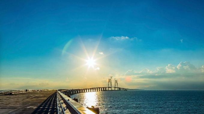 電力史上一次里程碑式工程,港珠澳大橋集橋梁、海底隧道和人工島為一體。為了確保大型船只在世界上最繁忙的黃金水道之一的伶仃洋航道暢通無阻，并避免影響飛機(jī)在香港國際機(jī)場的安全起降，港珠澳大橋并沒有全部采用橋梁結(jié)構(gòu)，而是在經(jīng)過伶仃洋航道時(shí)采用海底沉管隧道，并通過東、西兩座人工島將隧道與海上橋梁相連。